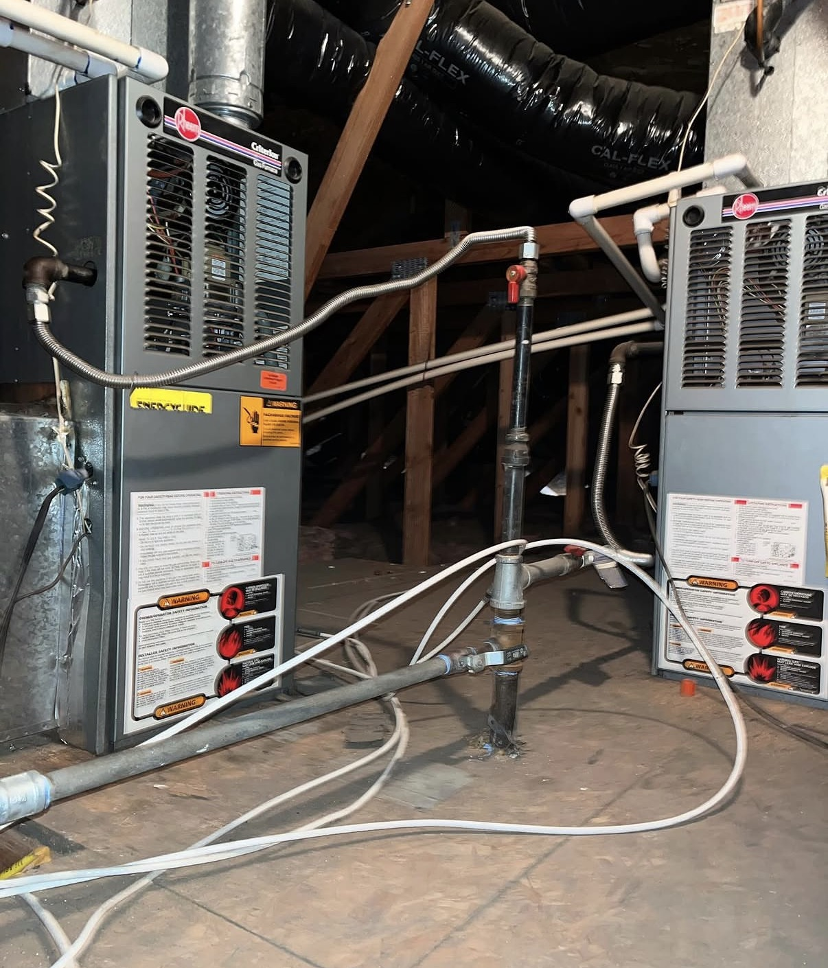 Two Rheem gas furnaces and ductwork installed in an attic